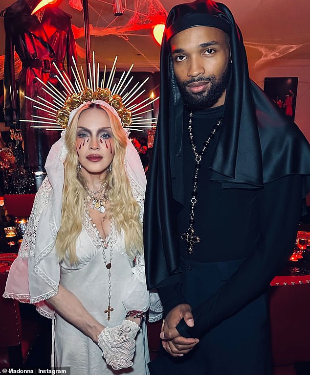 On Halloween, Madonna wore a white floor-length dress, complete with a plunging neckline and a white lace veil, and said she was dressed as a 