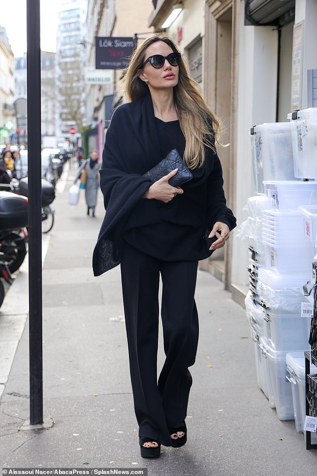 The 49-year-old actress - currently on location in the French capital as she films new movie Stitches - stepped out in a black wool scarf which she teamed with flared black trousers