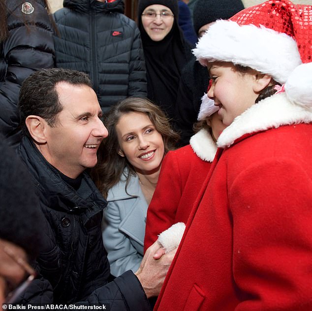 Syrian President al-Assad and his wife Asma visit the Sednaya Monastery and meet children and religious personalities on Christmas Day in Sednaya, near Damascus, Syria on December 25, 2016