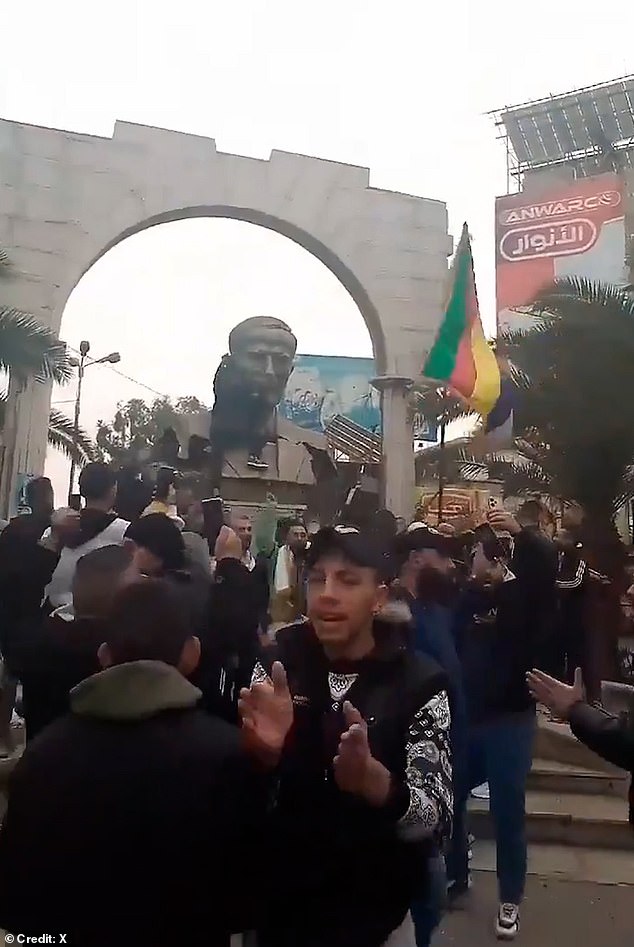 People in Damascus topple a statue of Hafez al-Assad and wave a Druze flag as rebels approach the capital, on December 7