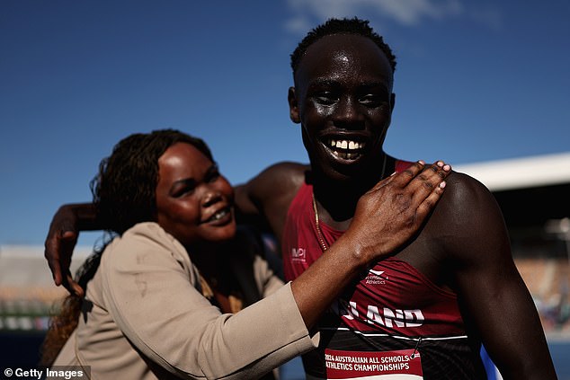 Gout Gout celebrates his recent success with his mother after breaking the 200m record