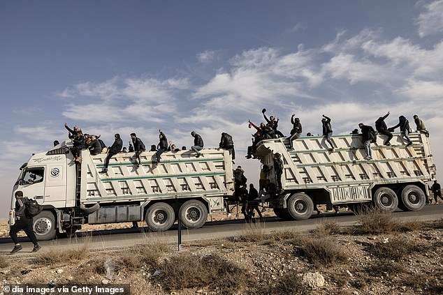 A group of regime supporters, including soldiers, flee the city of Damascus in Syria