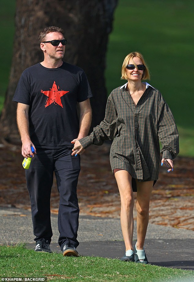 The couple looked very much in love as they enjoyed a summer walk, holding hands and soaking up the sun