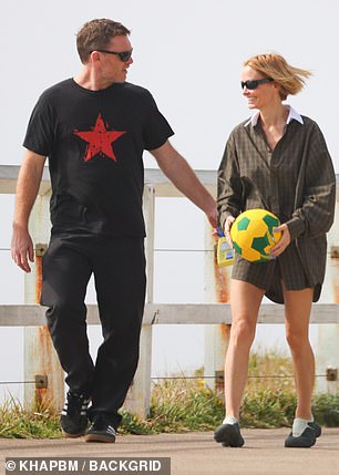 Even another loving gesture – Sam putting his arm around Lara's waist – can't take her eyes off the ball