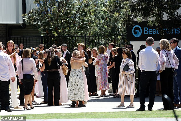 Mourners gather outside Beaumaris Secondary College on Monday