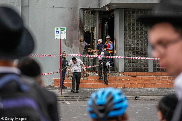 Synagogue members retrieve items from the Adass Israel Synagogue on December 6