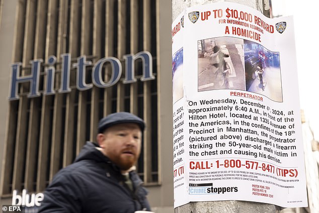 A 'Wanted' poster is hung by New York City police outside the Hilton hotel in New York, near where UnitedHealthcare CEO Brian Thompson was shot dead