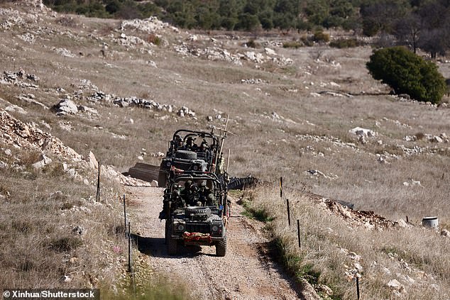 Israeli troops are seen near the buffer zone on the Golan Heights