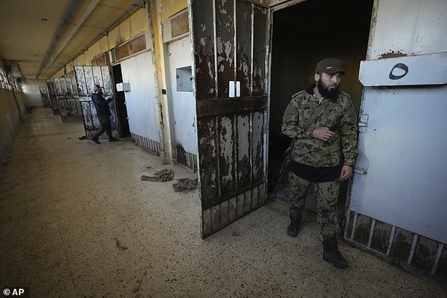 Rebels inspect the cells of the infamous Saydnaya military prison