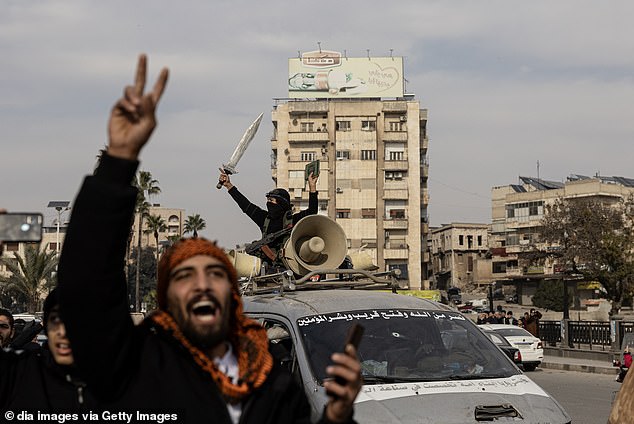 Local residents celebrate after opposition forces led by HTS (Hayyet Tahrir al-Sham) took control of Hama city center and surrounding villages on December 6