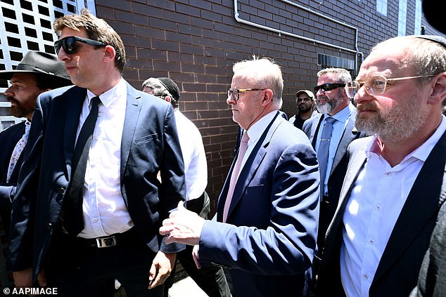 AFP officers were forced to shout at bystanders, urging them to 'keep your distance' and 'be careful, be careful, get back' as his motorcade tried to leave