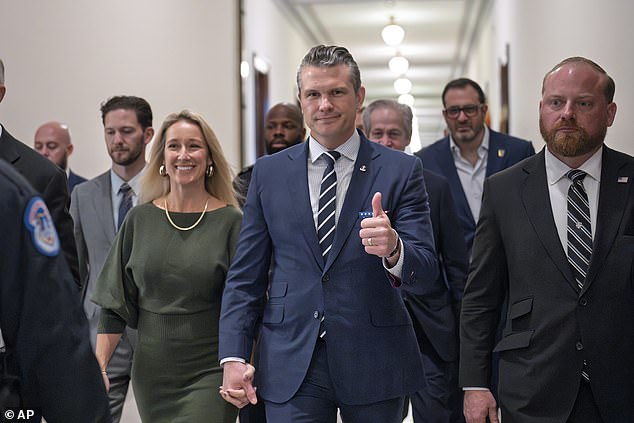 Pete Hegseth (center) walks through a Senate office building with his wife Jennifer Rauchet (left) as he heads to a meeting with a key tie-breaking vote, Senator Joni Ernst of Iowa