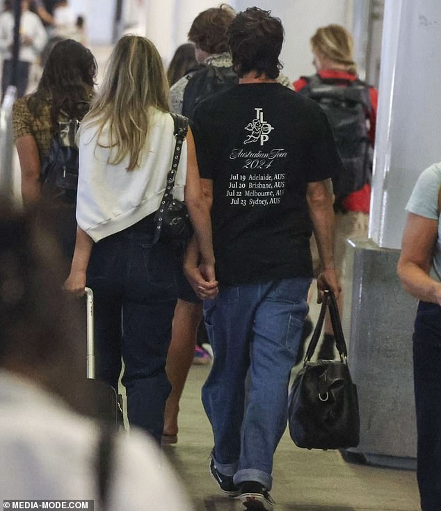 Tim and Lizzie, 15 years his junior and producer for Nova's Fitzy & Wippa, cuddled close as they walked through the terminal