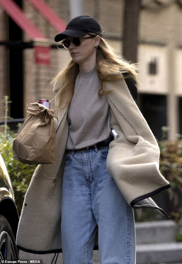 The soon-to-be star looked effortlessly stylish as she wrapped herself in a sherpa-lined, brown leather trench coat. She left the long coat open to reveal the taupe sweater she tucked into a pair of wide-leg jeans and a thin black belt.