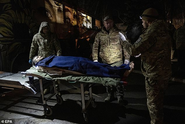 Medical personnel of the Knights Hospitaller carry a wounded Ukrainian soldier in their medical bus for transport to a hospital, in Donetsk region, Ukraine, December 6, 2024