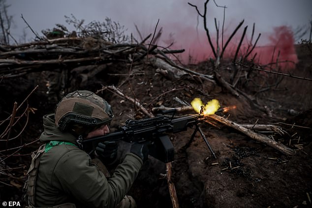 A soldier of the 24th Mechanized Brigade of the Ukrainian Armed Forces fires his weapon in the Donetsk region, eastern Ukraine