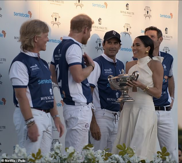 After the match, which Harry and his teammates won, the Duchess presented her husband with a trophy