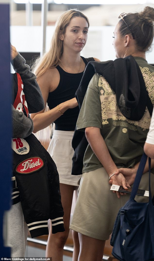 GK was seen at the flight check-in counter with her footballer girlfriend Ella Rutherford, who wore a baggy T-shirt and basketball shorts