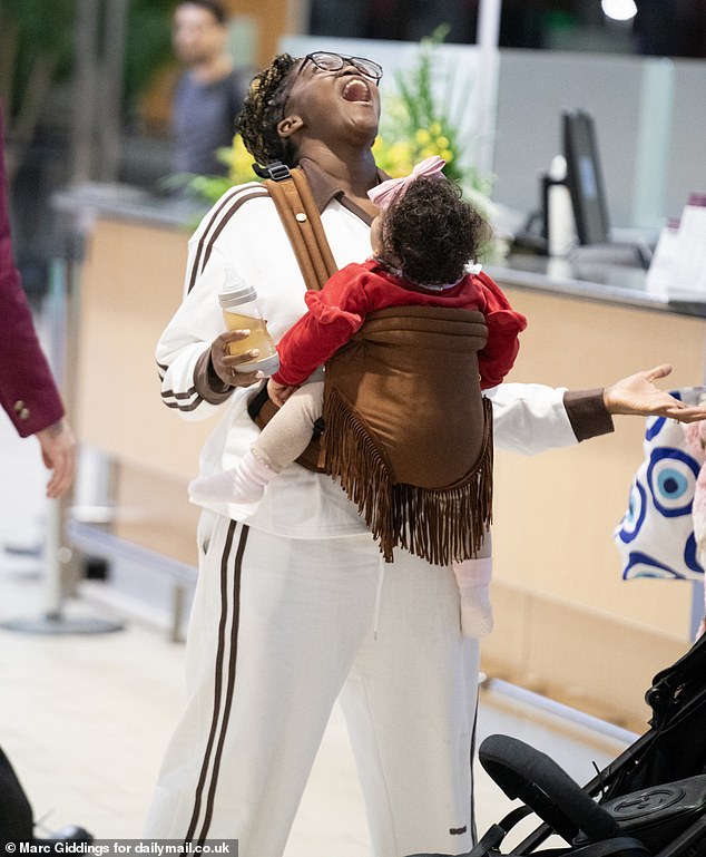 The former Strictly pro, 34, was heading through Brisbane Airport and had her daughter in a baby carrier as they walked around