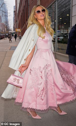 The influencer, 43, appeared to emulate Glinda, the 'good' witch from Wicked. For her 'magical' look, the reality star opted for a pastel pink dress with short sleeves, an A-line waist and a large floral print.