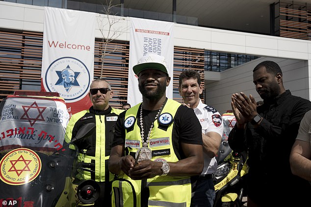 Floyd Mayweather, (center) after deploying a fleet of ambucycles that he donated to emergency services in Ramle, Israel