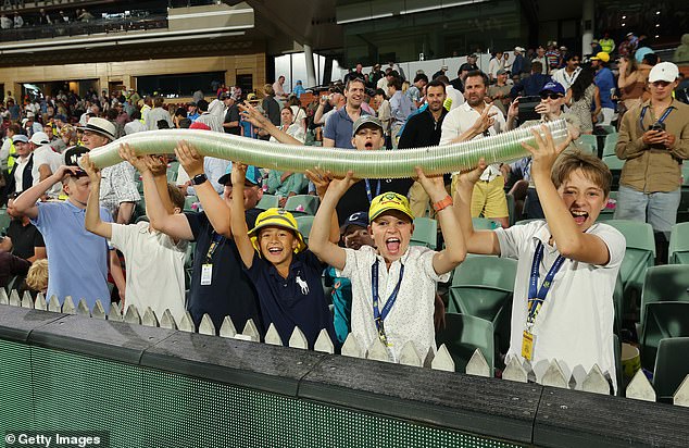 Burtt, 21, helped build the snake at the Adelaide Oval with seven friends - and soon there were up to 250 cups in use during the day-night Test (pictured, young fans with the crowd pleaser)