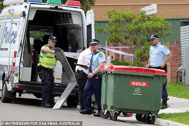 Police are seen outside the house in Sydney's south-west on Wednesday