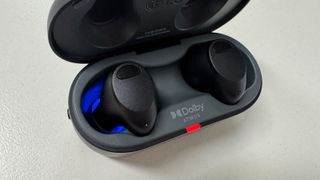 LG ToneFree T90S earbud case opened to reveal blue UV light inside