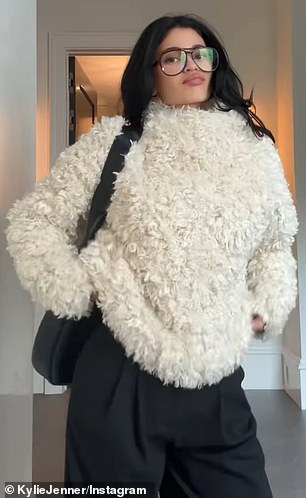 Jenner modeled a cream-colored faux fur sweater and loose-fitting black pants