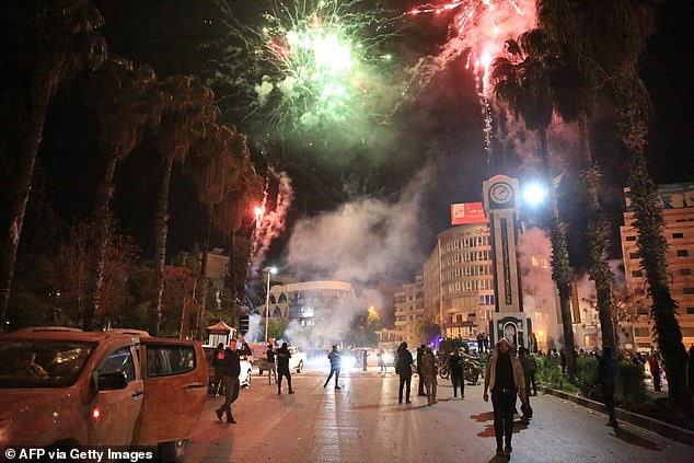 Syrians celebrate in the central square of Homs in early December