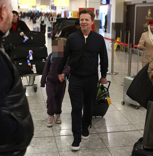 Donnelly appeared in good spirits as he made his way through Heathrow Terminal 2