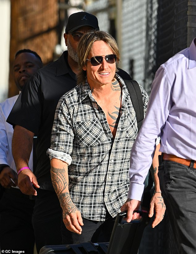 The Australian country music star, 57, smiled as he left the studio after appearing as musical guest on the late night talk show