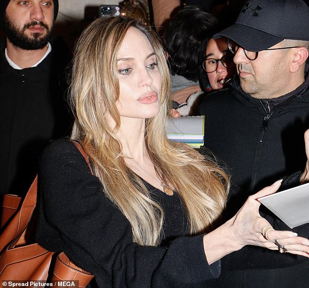 Angelina was all smiles as she made her way through the crowd of fans to a waiting car