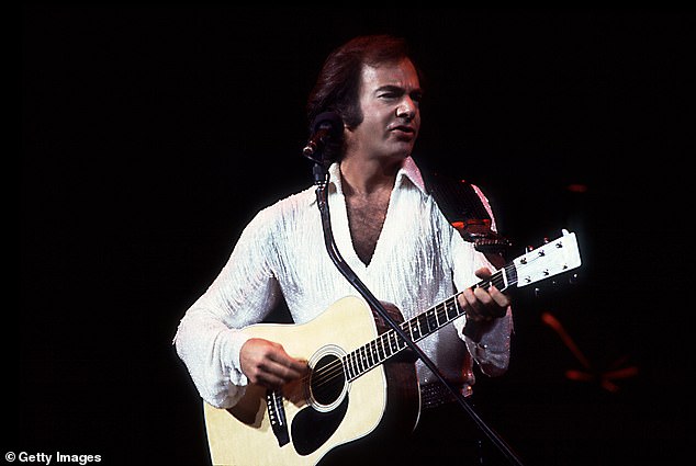 The X-Men star had grown his sideburns to channel Neil Diamond (pictured in 1983) for his new film