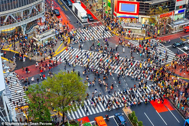 Shibuya Crossing stops all cars every 80 seconds as up to 3,000 people wait for the lights to turn green before scrambling in all directions across five crosswalks