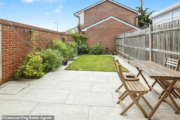 Ready to move in: The rear garden has a patio, lawn and access to allocated parking spaces