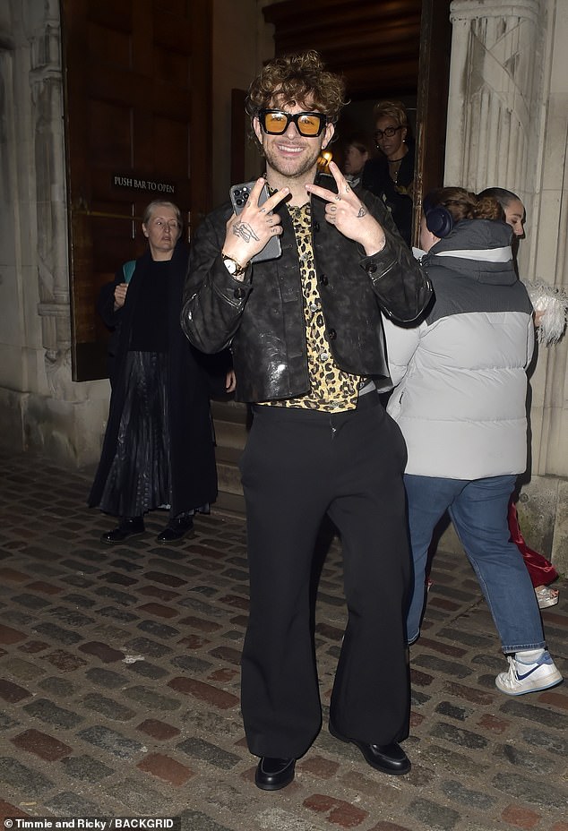 Tom Grennan looked cool in a leopard print top and leather jacket