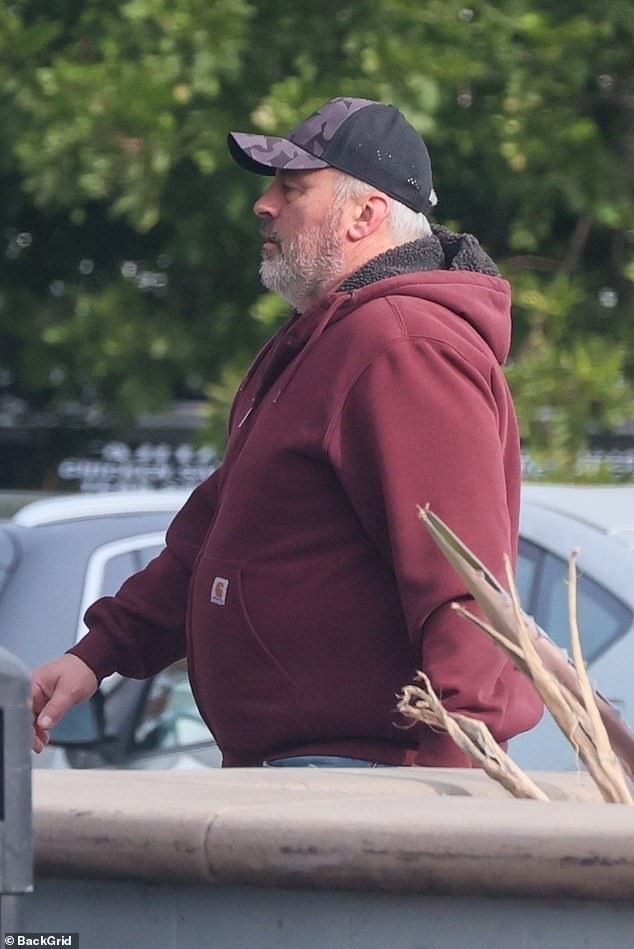 He kept it casual, with a burgundy sweatshirt and a Mercedes-Benz branded hat