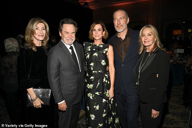 The Sex and the City star, 63, wore a sharp navy blue suit with a khaki shirt underneath and dress shoes (L-R Carolyn Espley, Dennis Miller, Kristen Wiig, John ad Bo)