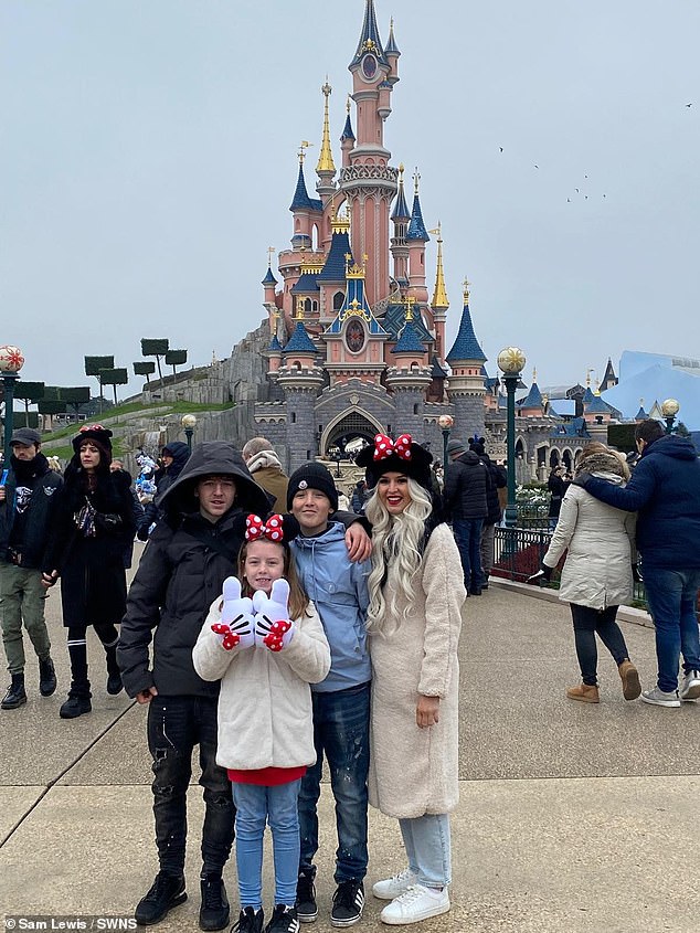 Happier times: Mrs. Lewis and her three children enjoy a family trip to DisneyLand Paris before she became ill.