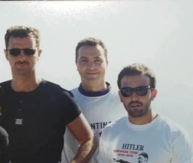 Unearthed family photos of the tyrant show one of him apparently out for a walk and happily standing next to a cousin wearing a T-shirt with the image of Adolf Hitler