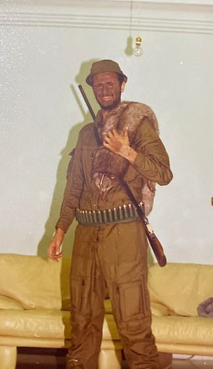 In one photo, he is seen in a khaki hunter costume with a gun and a fur accessory