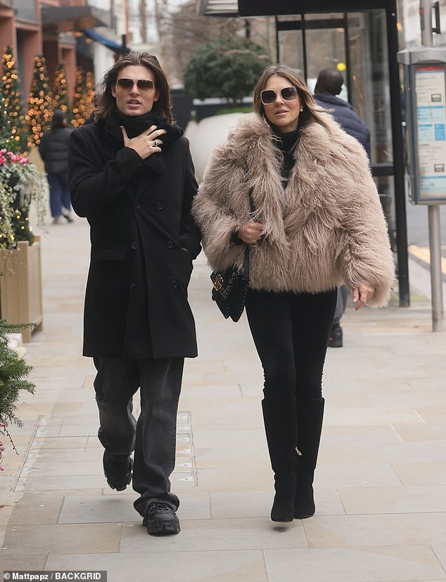 The actress, 59, wrapped up warm in a chic faux fur coat and black leggings as she was pictured strolling down the street with her son, 22, after a visit to Temperley on Sloane Street