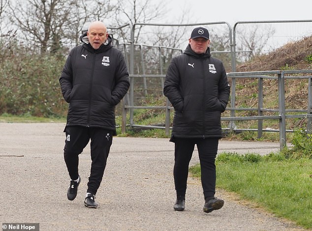 He dressed warmly in a black padded jacket as he stepped out with newly appointed former Manchester United first-team coach Mike Phelan.