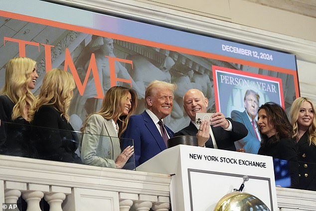 President-elect Donald Trump stands for a selfie after ringing the opening bell