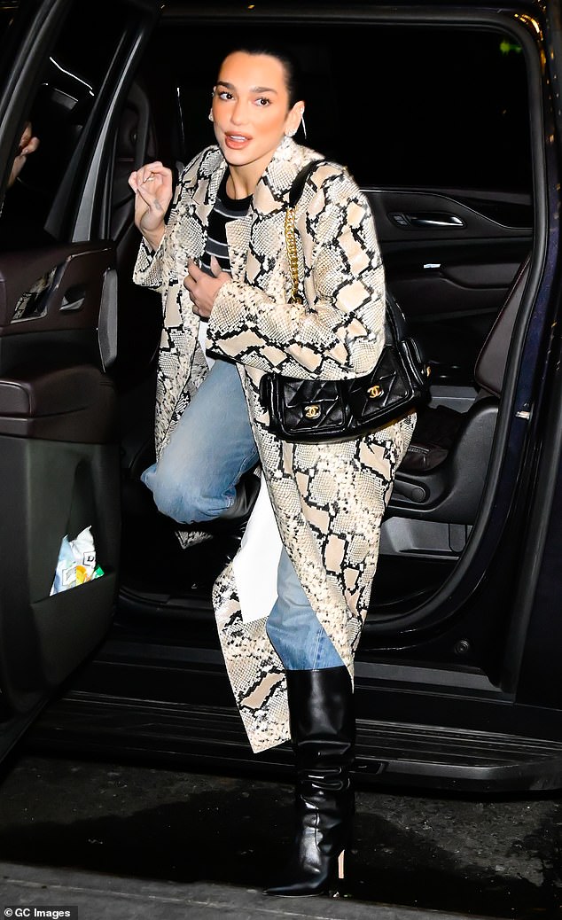 Dua looked effortlessly chic as she arrived in a long snake print coat, which she paired with relaxed light jeans