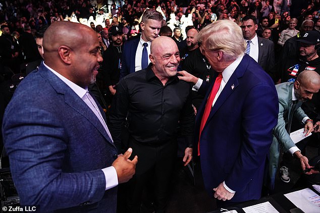 Daniel Cormier, Joe Rogan and President-elect Donald Trump talk during the UFC 309 event at Madison Square Garden on November 16, 2024 in New York City. Trump spoke about the importance of his interview with Rogan during the campaign and accused Kamala Harris of insufficient media involvement