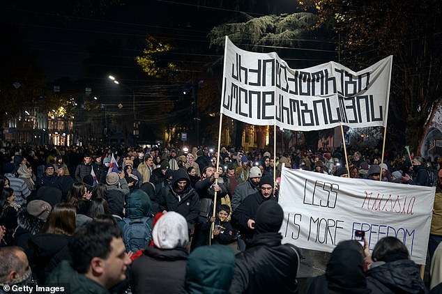 People gathered to protest the results of last month's parliamentary elections outside the Parliament Building on December 9, 2024 in Tbilisi, Georgia