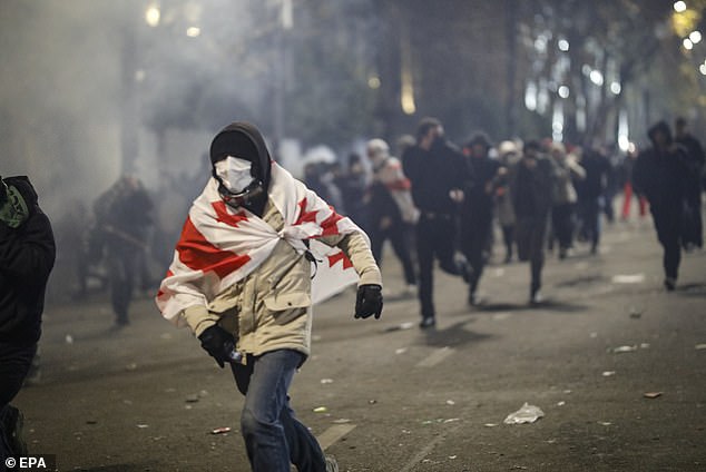 Police use tear gas to disperse Georgian opposition supporters protesting in front of the parliament building in Tbilisi, Georgia, November 30, 2024