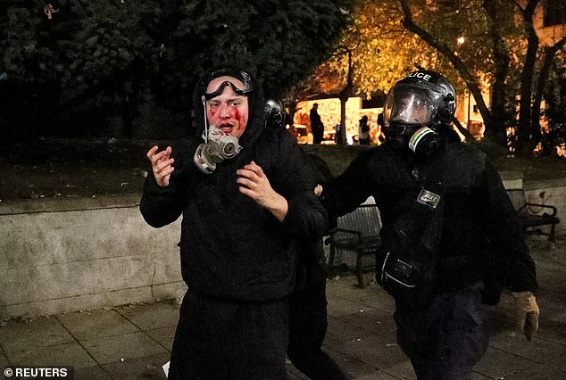 Police officers escort a demonstrator during a meeting of supporters of opposition parties, protesting against the new government's decision to suspend accession negotiations with the European Union and refuse budget subsidies until 2028, in Tbilisi, Georgia, November 30, 2024